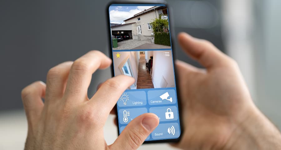 Person looking at surveillance camera streams on a cell phone